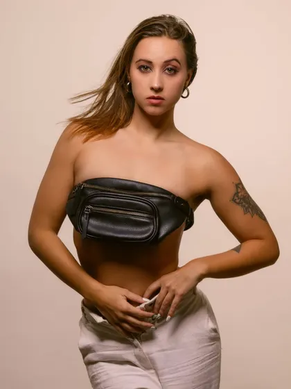 A unique fashion shot where a fanny pack is styled as a top. This creative choice makes for a memorable and edgy portrait.