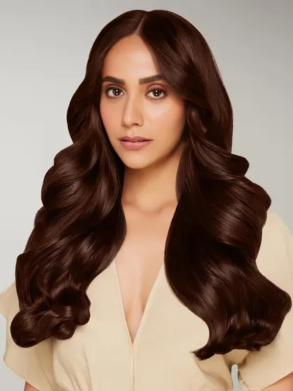 Another key visual for a BBlunt hair color campaign. This portrait captures a model with rich, chocolate brown hair styled in voluminous waves, representing an ideal hair color result for product packaging.