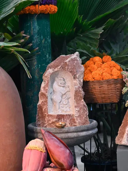 A unique stone fountain featuring a carving of Hanuman within a natural rock formation. This piece was part of our Sankranthi collection, celebrating the harvest season with artisanal decor.
