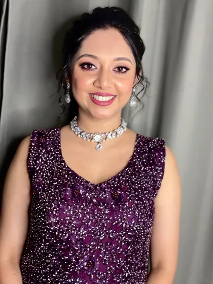 A beautiful smile from a happy client, ready for an evening party. I created this look with a focus on shimmery eyes and a radiant complexion to match her sparkling purple dress.