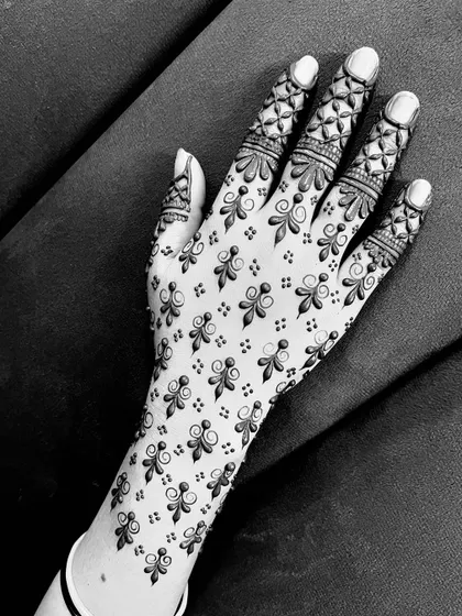 A beautiful black and white image of a delicate back-hand design, perfect for any festive occasion.
