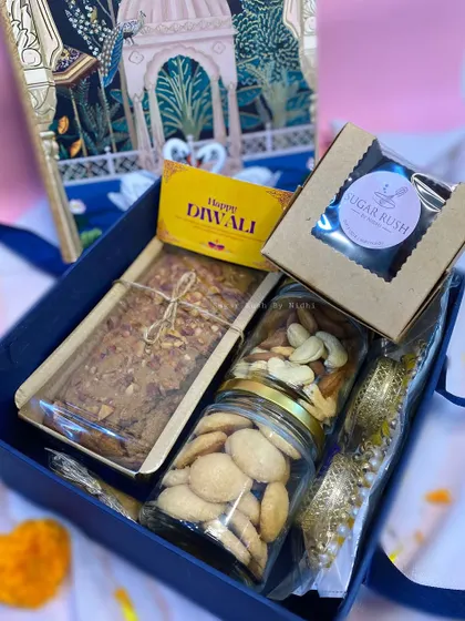 The 'Diwali Delight Box' is a grand gesture, including a tea cake, nut and cookie jars, a brownie box, and festive diyas.