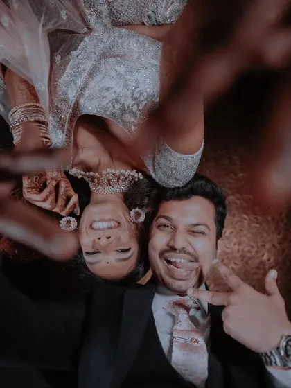Another playful selfie from below, capturing the couple's fun-loving personalities and the joy of their celebration.