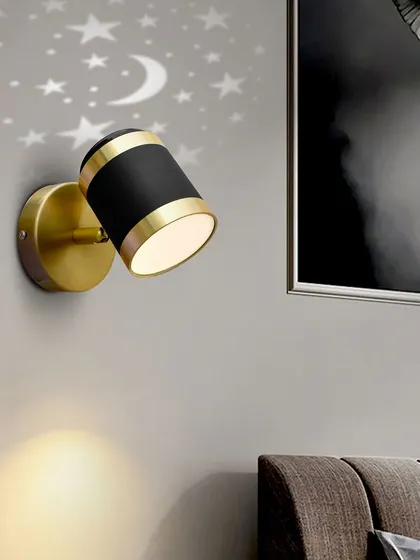 The star-projecting spotlight shown in a bedroom setting.