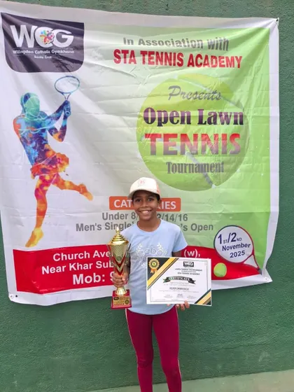Liticia Fernandes proudly holding her trophy and certificate after an excellent performance at the Open Lawn Tennis Tournament. Her grit and determination are an example for all our players.