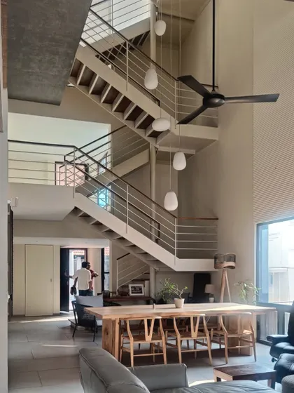 The staircase is a central feature of the home, visible from the main living and dining areas.