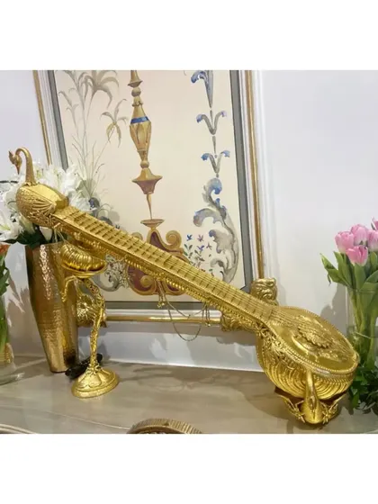 A beautiful golden sitar, an artifact from our Hyderabad event, symbolizing the richness of our musical tradition.