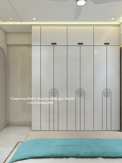 The wardrobe in this bedroom features a clean, minimalist design with unique semi-circular handles, adding a touch of modern geometry.