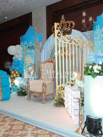 A side view of the prince-themed stage, highlighting the custom-built carriage, throne chair, and gated backdrop, all designed to create a multi-dimensional and interactive space.