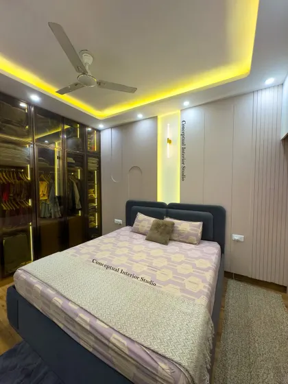 This bedroom features a luxurious walk-in style wardrobe with smoked glass doors and internal lighting, making getting ready feel like a boutique experience.