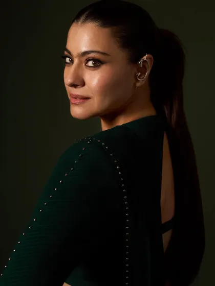 This angle highlights the unique ear cuff and the sleek ponytail, adding a contemporary edge to the red carpet look.