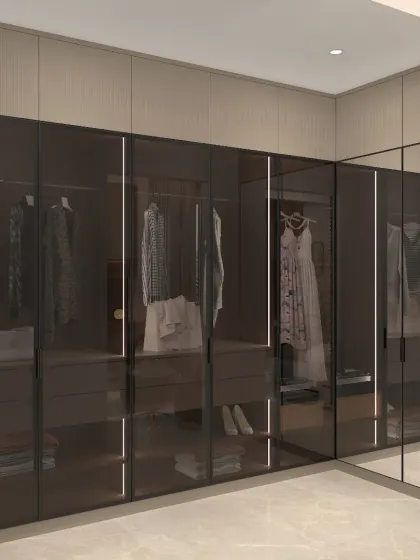 For the ultimate in organization and style, we designed this walk-in closet with smoked glass doors and integrated lighting. The layout provides a clear view of the contents while maintaining a sleek, high-end look.