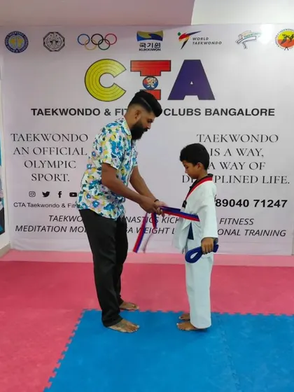 Tying a purple belt.
