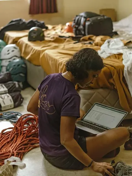 A volunteer meticulously checks the gear inventory on a laptop. This behind-the-scenes work is crucial for running a smooth and safe event.