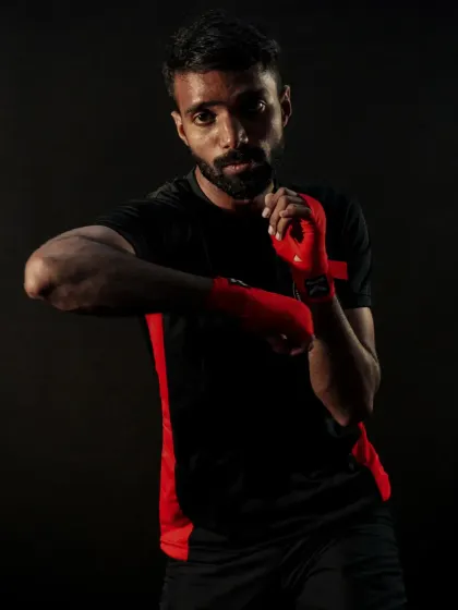 The focused gaze of a fighter. This portrait captures the intensity and determination we cultivate in our athletes.