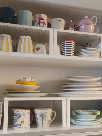 Here is a look at a recently organized crockery cabinet. By using shelf risers, we were able to neatly stack plates, bowls, and mugs, making the space both pretty and functional.