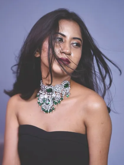 This shot captures the wind-swept, editorial feel of the look, with the Victorian choker as the centerpiece.