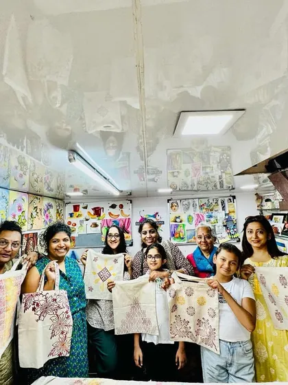 The best part of our workshops is the community. Here's a wonderful group from our World Art Day session, proudly showing off the unique tote bags they designed and printed themselves.