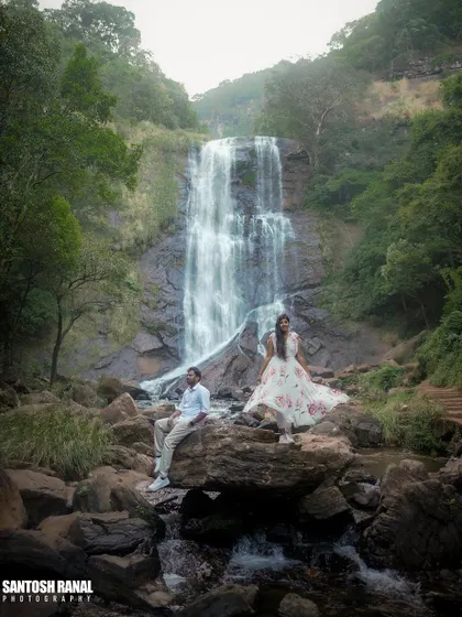 A wide shot that captures the scale of the waterfall and the serene beauty of the location.