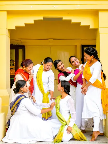 A candid moment between our senior disciples during a photoshoot for Varshik Utsav, embodying the spirit of 'sakhi' (friendship).
