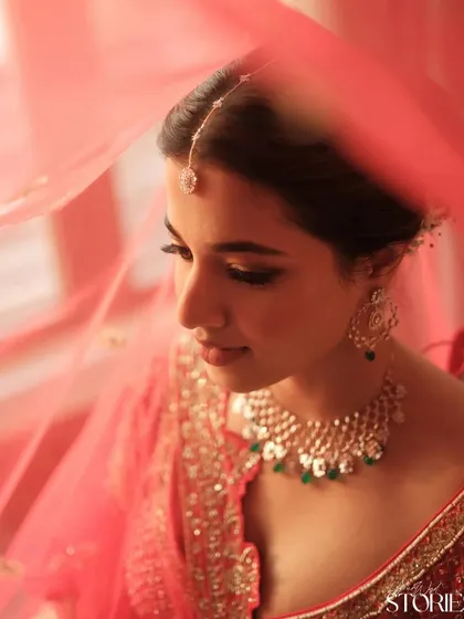 A dreamy close-up through the veil, focusing on the soft eye makeup and glowing skin. This look is all about creating an ethereal and romantic bridal moment.