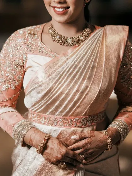 A closer view of the fully embroidered sheer sleeves and the matching embroidered belt, which helps define the waist and complete the look.