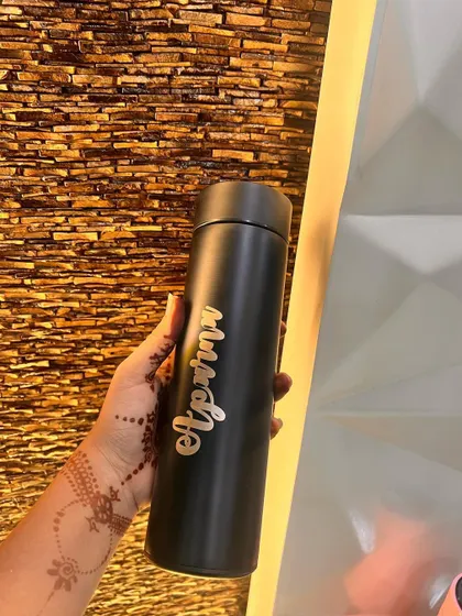 My custom temperature-controlled bottles are perfect for keeping your drinks hot or cold. This one is personalized with the name "Apurva" in an elegant gold script on a matte black bottle.