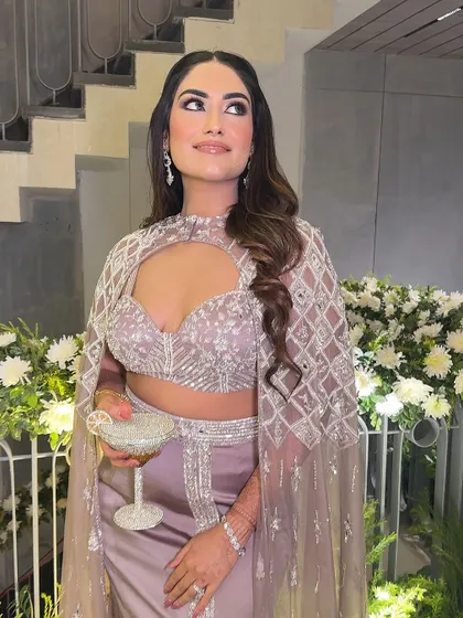 A candid moment enjoying the festivities. The makeup remains flawless, and the highlighter catches the light beautifully.