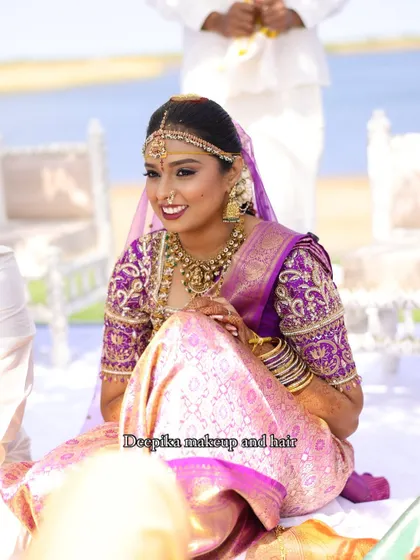 Another happy moment from the Chicago wedding, with the bride looking radiant in her purple and pink silk saree.