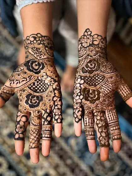 This design features a mix of bold floral work and delicate checkerboard patterns. It's a beautiful example of how I combine different elements to create a unique Arabic-style mehendi.