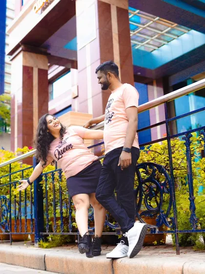A fun and relaxed moment from an urban pre-wedding shoot. The couple's matching "King" and "Queen" t-shirts add a playful touch.