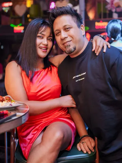 A couple posing for a photo during the party.