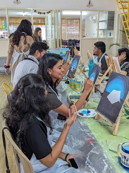 A shot of our canvas painting workshop in full swing, with participants focused on their easels.