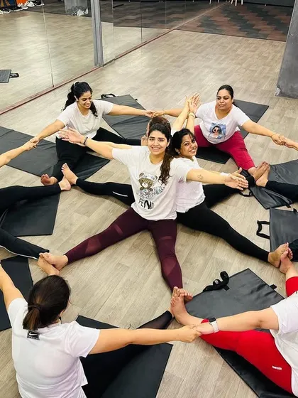 Another angle of our community circle, with a member at the center feeling the collective energy. These group activities are a core part of what makes our studio special.