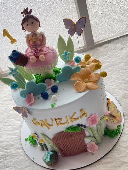 Welcome to the fairyland. This cake is perfect for a first birthday, with a sweet little fairy sitting on a mushroom surrounded by flowers and butterflies.