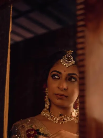 A mirror shot of Leona Lishoy from the 'Zamani' set. The styling aimed to capture a feeling of nostalgia and introspection, with the ornate jewelry and soft focus adding to the dreamy atmosphere.
