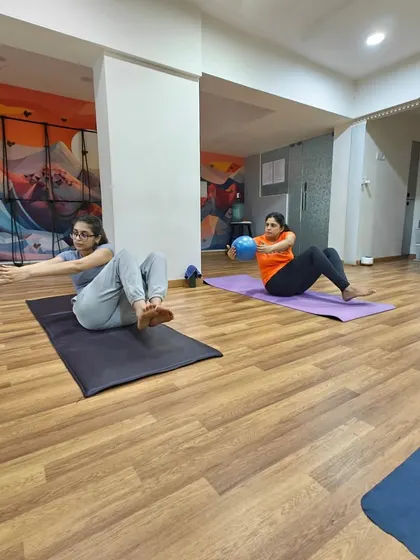 We incorporate props like stability balls to engage the core in a mindful way. This is more than just an ab workout; it's about finding your center and building stability from within, which is essential for both physical and mental balance.