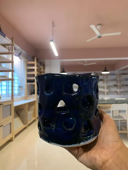This hand-built luminary, with its deep blue glaze and geometric cutouts, was made by an 11-year-old student. It’s a beautiful reminder that creativity and talent have no age limit.