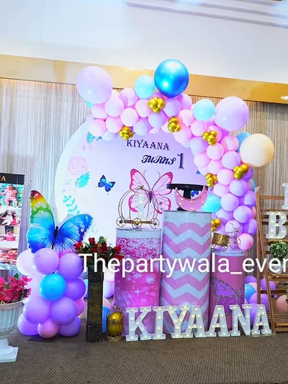 Another angle of Kiyaana's butterfly party, showing the full setup with a photo board.