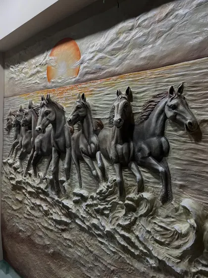 This close-up from the side emphasizes the high-relief sculpting, with the horses almost fully emerging from the background.