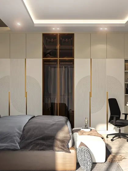 This bedroom blends luxury and functionality with a sleek, modern wardrobe that includes a glass-paneled section and an integrated study nook. The design is perfect for those who value sophisticated comfort and practicality.