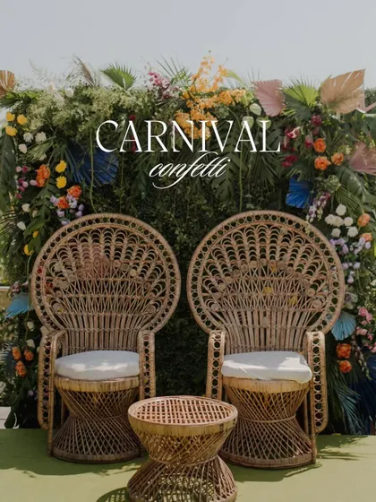 'Carnival Confetti' - a fun and festive Mehendi seating area with rattan peacock chairs and a vibrant green and floral backdrop.