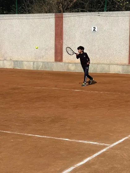 A junior player making contact with the ball on a forehand. We focus on teaching the correct contact point for optimal power and control.