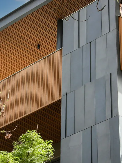 Another detail of the Poorvi Marg facade, showcasing the clean lines and the rich texture of the materials. The design is a perfect blend of sustainability and style.