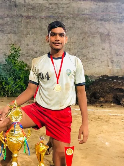 A proud player with his medals and trophies after securing first position.