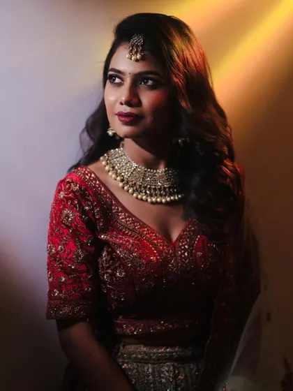 A stunning portrait of Sahana. Her reception makeup features a soft smokey eye and a berry lip color.