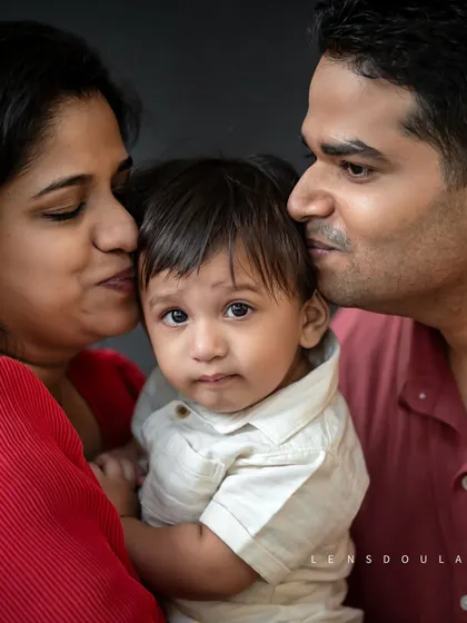 Sometimes the most powerful portraits are the simplest. This close-up captures the pure, overwhelming love of new parents, a quiet moment of family bliss that tells a whole story.
