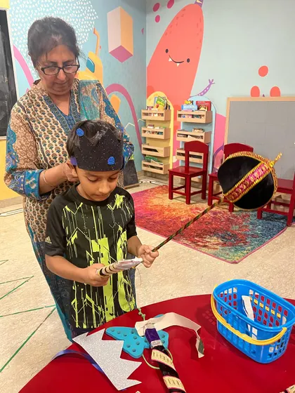 Getting ready for the big show. I help the children with their costumes and props, making sure everyone feels confident and ready to perform.
