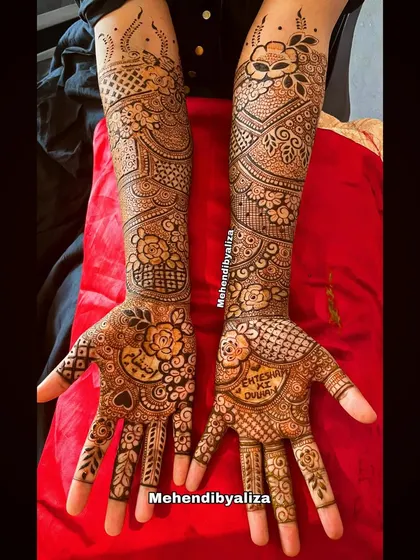 This floral-themed bridal henna is perfect for a modern bride. The design flows from dense patterns on the hands to more spaced-out florals on the arms.