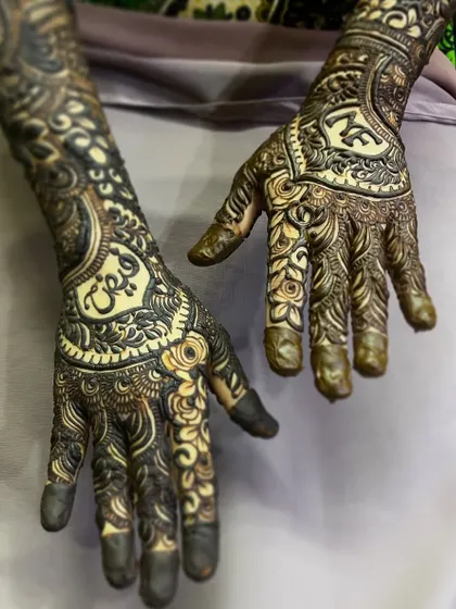 Learn to personalize bridal henna by elegantly weaving the groom's name into the design, as shown here.